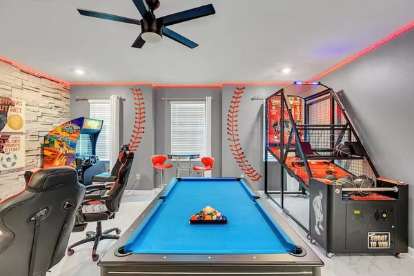 Modern townhouse exterior with landscaping, kitchen with island and pendant lights, dining room with glass table, and community water park with colorful slides